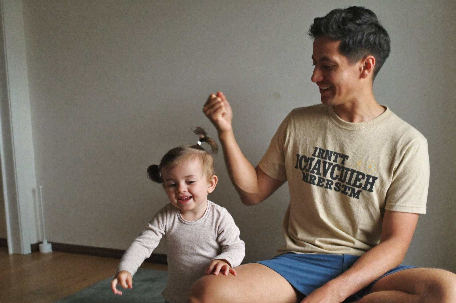 A present father playing with his young daughter at home